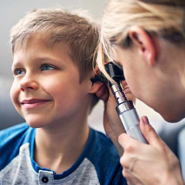 Happy little boy having ear exam