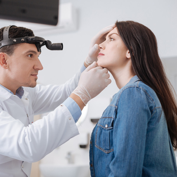 doctor looking at woman's nose