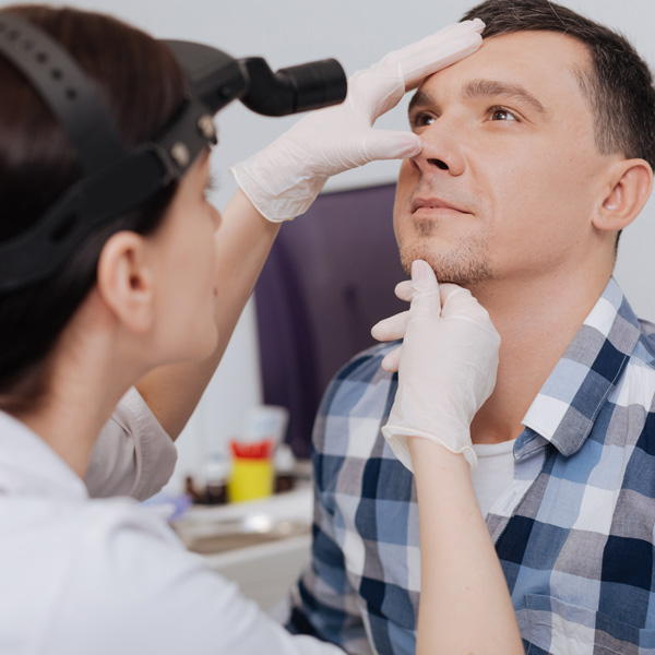 doctor looking at patients nose