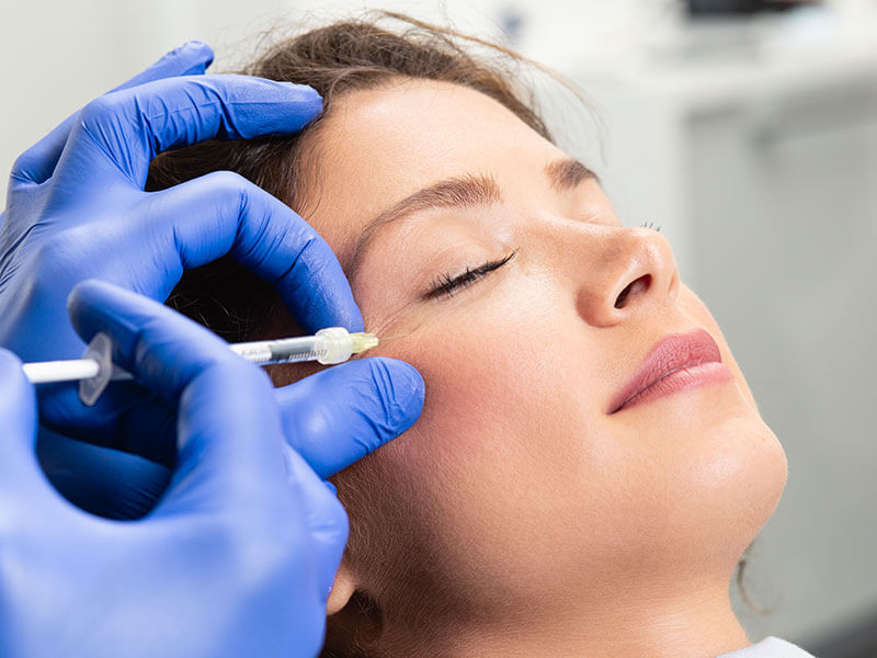woman receiving injection in face