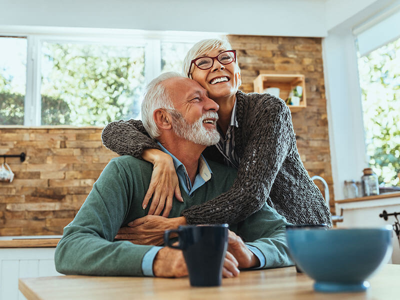 senior couple smiling together at home